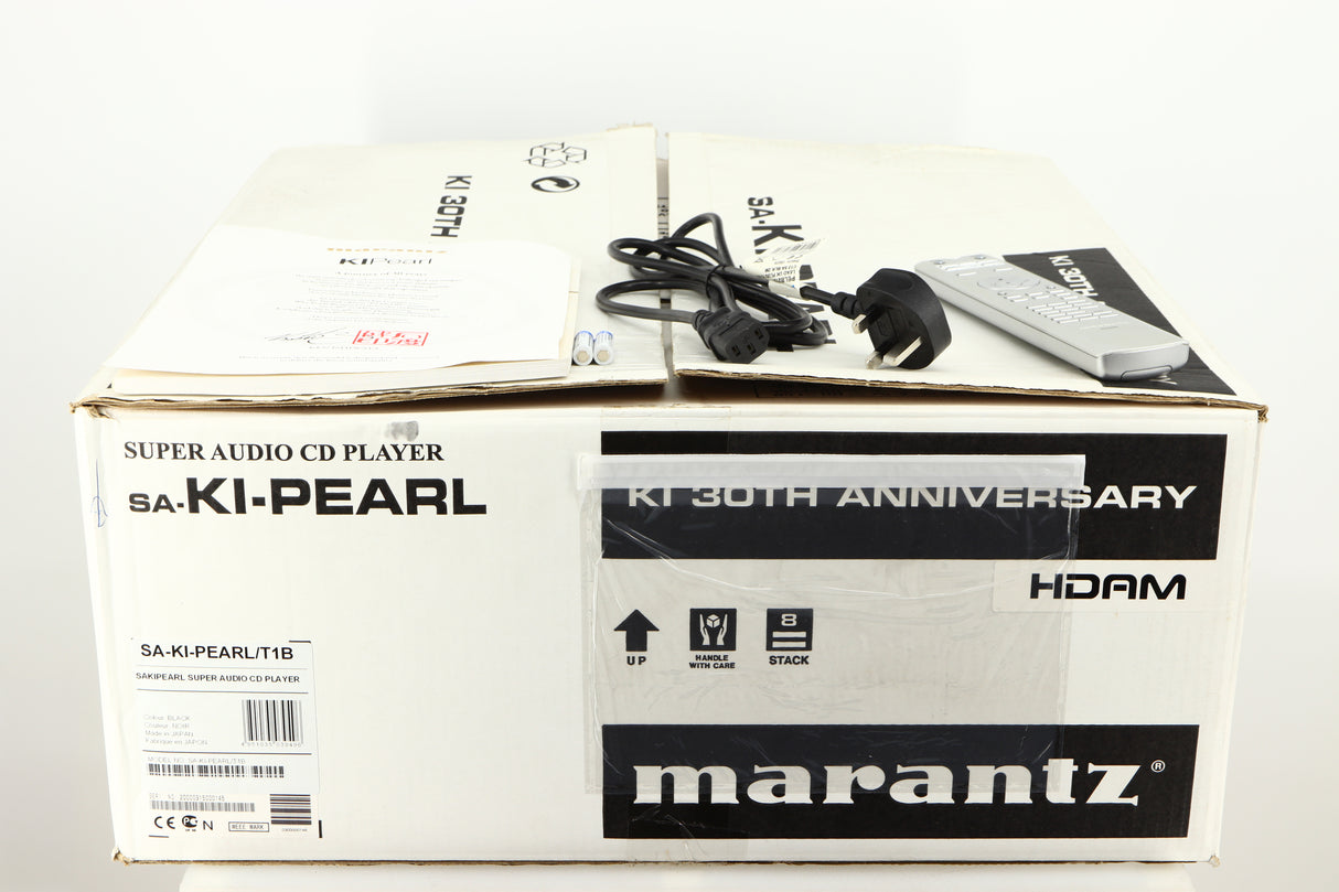 Box for a used Marantz 30th Anniversary SA-KI-PEARL SACD Player in a black finish showing Remote, 2x Batteries, Manual and Mains Cable