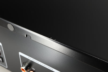 Close up of a used Marantz CD6007 CD Player in a black finish showing some scratching