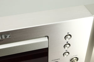 Close up view of a dent on the fascia of a used Marantz CD6007 CD Player in silver finish 