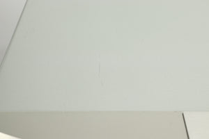 Close up view of a small scratch on the top of a used Marantz CD6007 CD Player in silver finish 