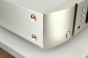 Close up view of the front left corner of a used Marantz CD6007 CD Player in silver finish 