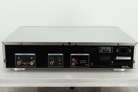 Rear view of a used Marantz CD6007 CD Player in silver finish showing RCA outputs, coaxial and optical inputs, and a power input