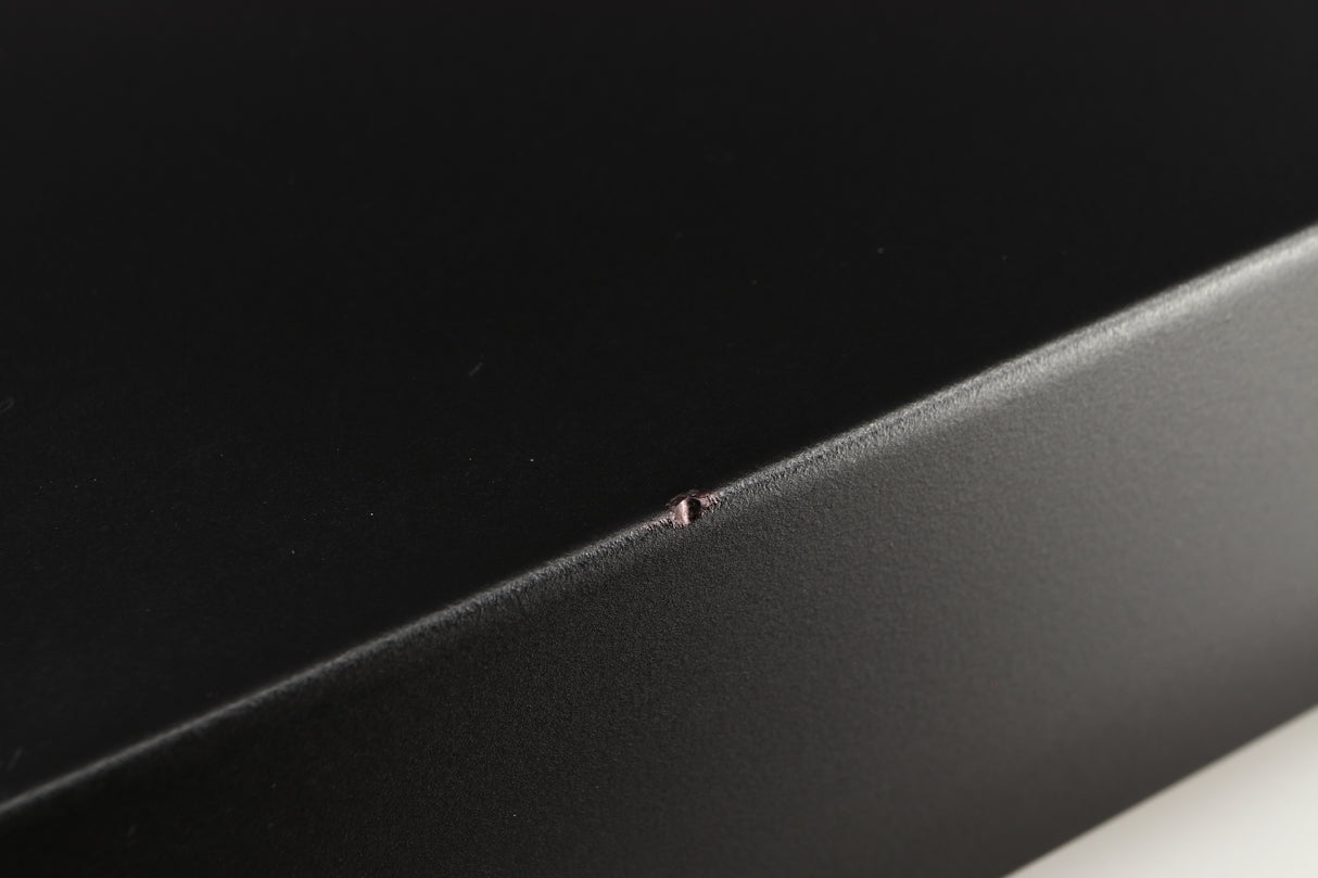 Close up of a used Marantz CD63 KI Signature CD Player in a black finish showing small nick on left edge