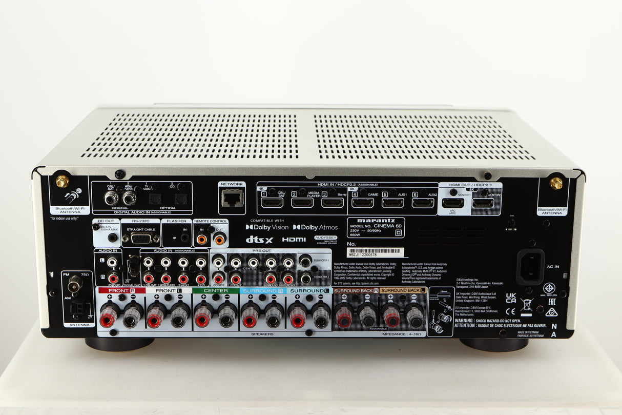 Rear view of a used Marantz Cinema 60 AV Receiver in a silver finish showing HDMI Inputs, HDMI Outputs, Mains Input, Speaker Outputs, Network Input, Optical Inputs, Phono Inputs and Phono Outputs