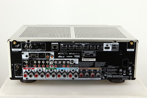 Rear view of a used Marantz Cinema 60 AV Receiver in a silver finish showing HDMI Inputs, HDMI Outputs, Mains Input, Speaker Outputs, Network Input, Optical Inputs, Phono Inputs and Phono Outputs