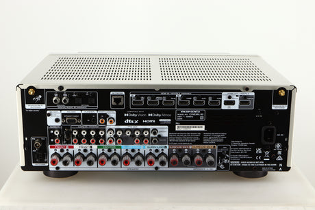 Rear view of a used Marantz Cinema 60 AV Receiver in a silver finish showing HDMI Inputs, HDMI Outputs, Mains Input, Speaker Outputs, Network Input, Optical Inputs, Phono Inputs and Phono Outputs