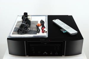 Top of a used Marantz KI Ruby Limited Edition SACD Player in a black finish showing Manual, Mains Cable, 2x Interconnect Cables, Remote and 2x Batteries