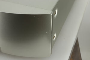 Close up view of the fascia of a used Marantz NA6005 Network Player in silver finish showing small dents