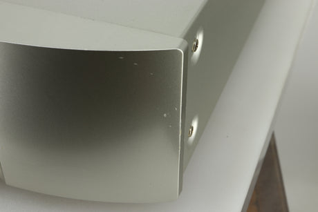 Close up view of the fascia of a used Marantz NA6005 Network Player in silver finish showing small dents