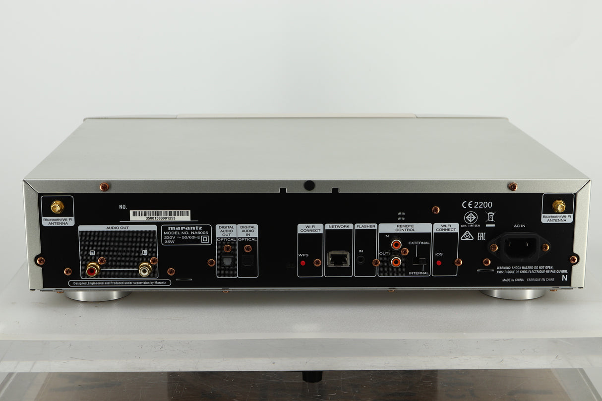 Back view of a used Marantz NA6005 Network Player in silver finish showing RCA outputs, Optical in and out, ethernet input, and mains input