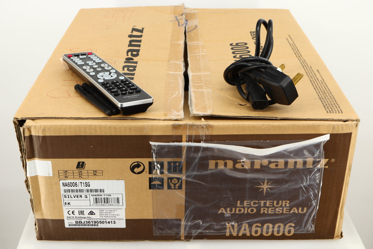 Box for a used Marantz NA6006 Network Player in a silver finish showing Mains Cable, Remote and 2x Bluetooth/Wi-Fi Antennas