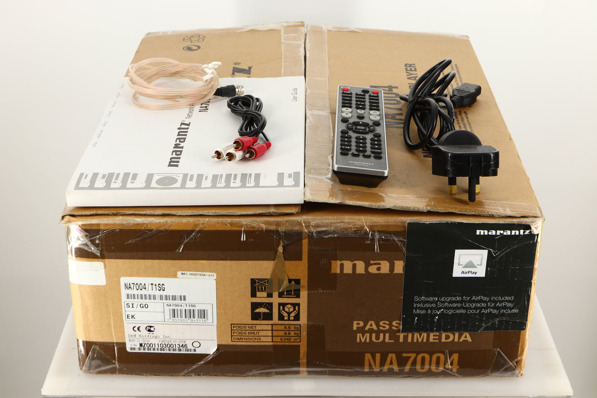 Box of a used Marantz NA7004 Network Streamer in Silver finish with manual, mains cable, remote, interconnects, and aerial