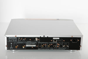 Rear view of a used Marantz NA7004 Network Streamer in a Silver finish showing Mains Input, Phono Inputs, Phono Outputs, Network Input, Optical Input and Optical Output