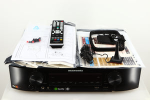 Top of a used Marantz NR1606 AV Receiver in a black finish showing Manual, Microphone Stand, Microphone, Square Loop Antenna and Remote