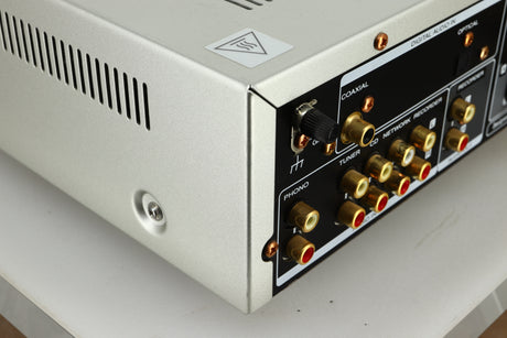 Close up view of the rear left corner of a used Marantz PM6005 Integrated Amplifier in silver finish