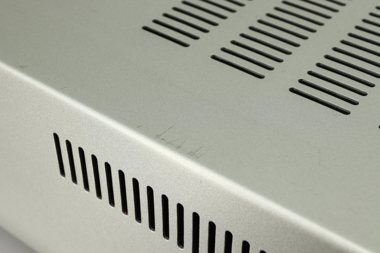 Close up view of the top of a used Marantz PM6005 Integrated Amplifier in silver finish showing scratches