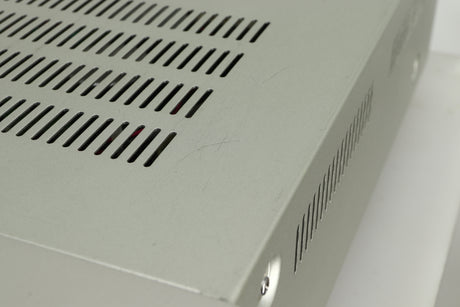 Close up view of the top of a used Marantz PM6005 Integrated Amplifier in silver finish showing scratches