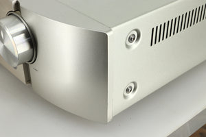 Close up view of the front right corner of a used Marantz PM6005 Integrated Amplifier in silver finish
