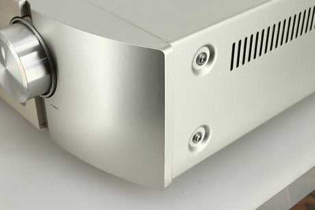 Close up view of the front right corner of a used Marantz PM6005 Integrated Amplifier in silver finish