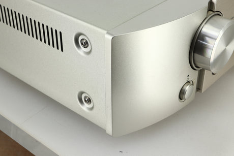 Close up view of the front left corner of a used Marantz PM6005 Integrated Amplifier in silver finish