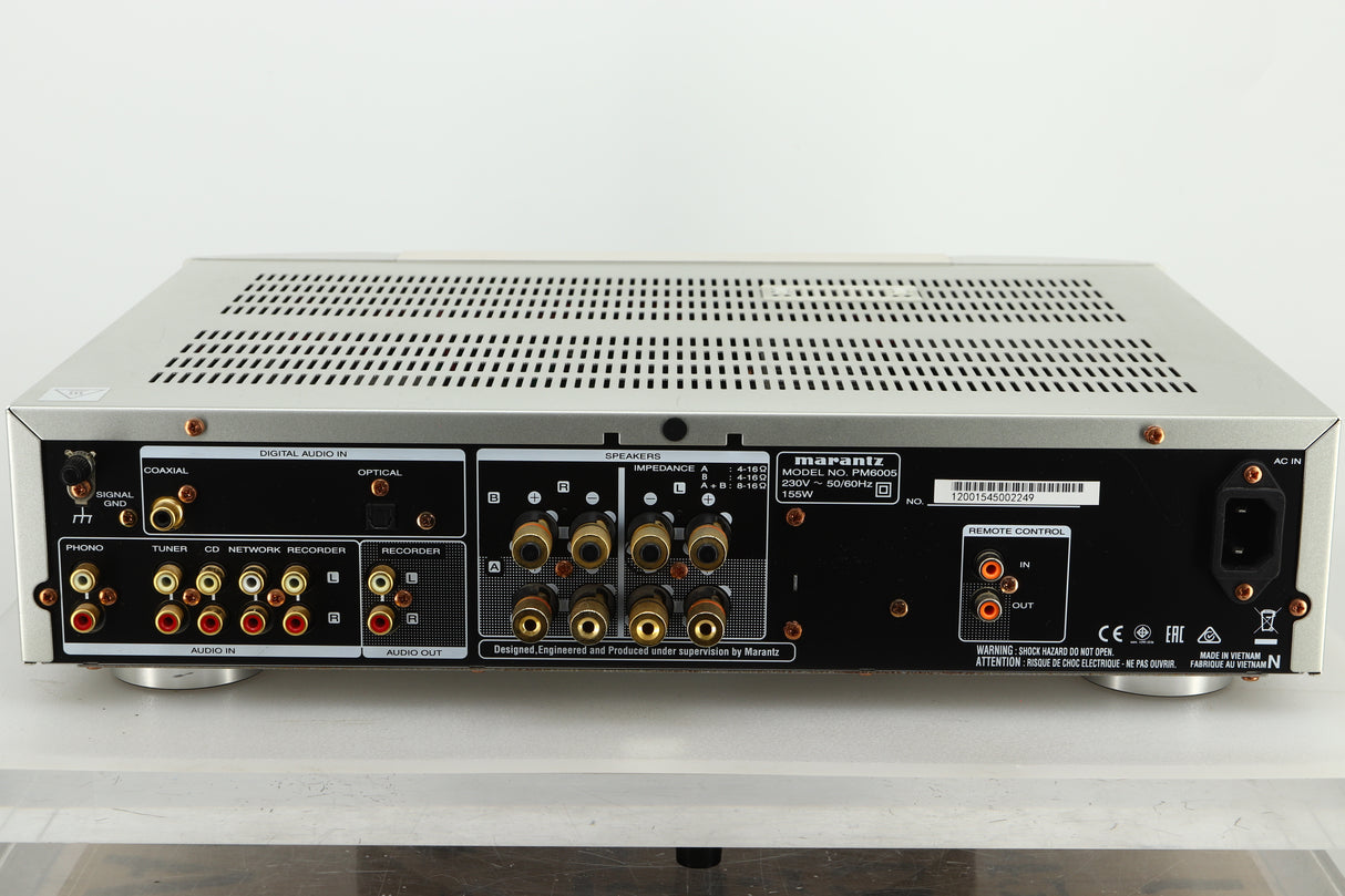 Rear view of a used Marantz PM6005 Integrated Amplifier in silver finish showing RCA, coaxial, and optical inputs, speaker outputs, and a power input