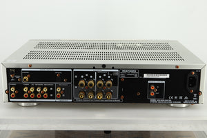 Rear view of a used Marantz PM6005 Integrated Amplifier in silver finish showing RCA, coaxial, and optical inputs, speaker outputs, and a power input