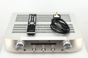 Box of a used Marantz PM6006 UK Edition Integrated Amplifier in Silver finish showing remote, and mains cable