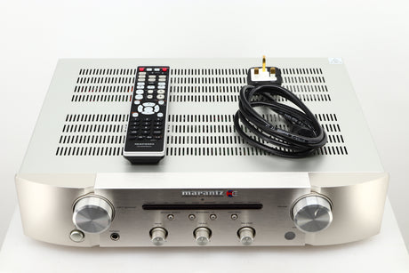 Box of a used Marantz PM6006 UK Edition Integrated Amplifier in Silver finish showing remote, and mains cable