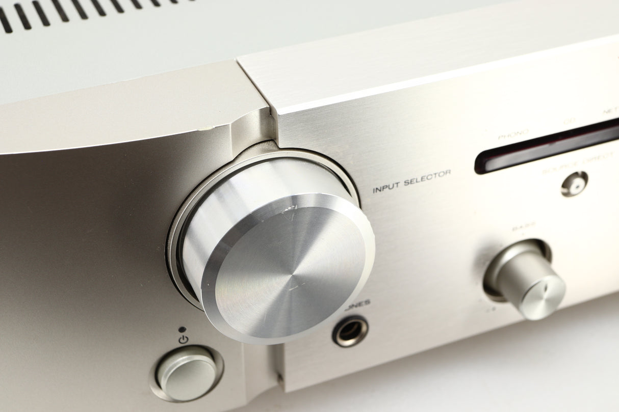 Close up view of a used Marantz PM6006 UK Edition Integrated Amplifier in Silver finish showing scratching on the knob 