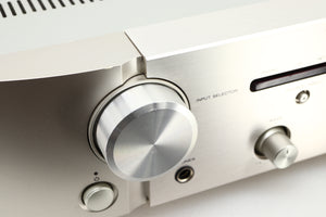 Close up view of a used Marantz PM6006 UK Edition Integrated Amplifier in Silver finish showing scratching on the knob 