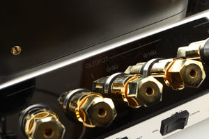 Close up view of a used McIntosh MC275 MK VI Power Amplifier showing scratching on the metal finish 
