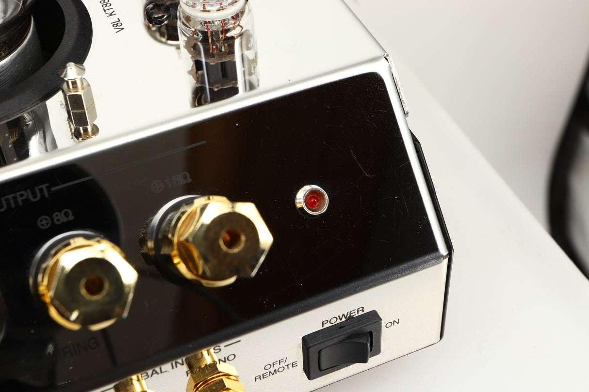 Close up view of a used McIntosh MC275 MK VI Power Amplifier showing scratching on the metal finish 