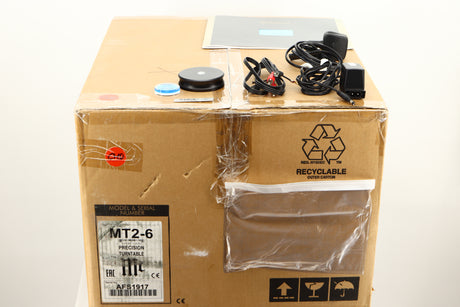 Box of a used McIntosh MT2 Turntable showing Mains Cable, Manual, Spirit Level, Stylus force gauge, Interconnects, and Record Clamp