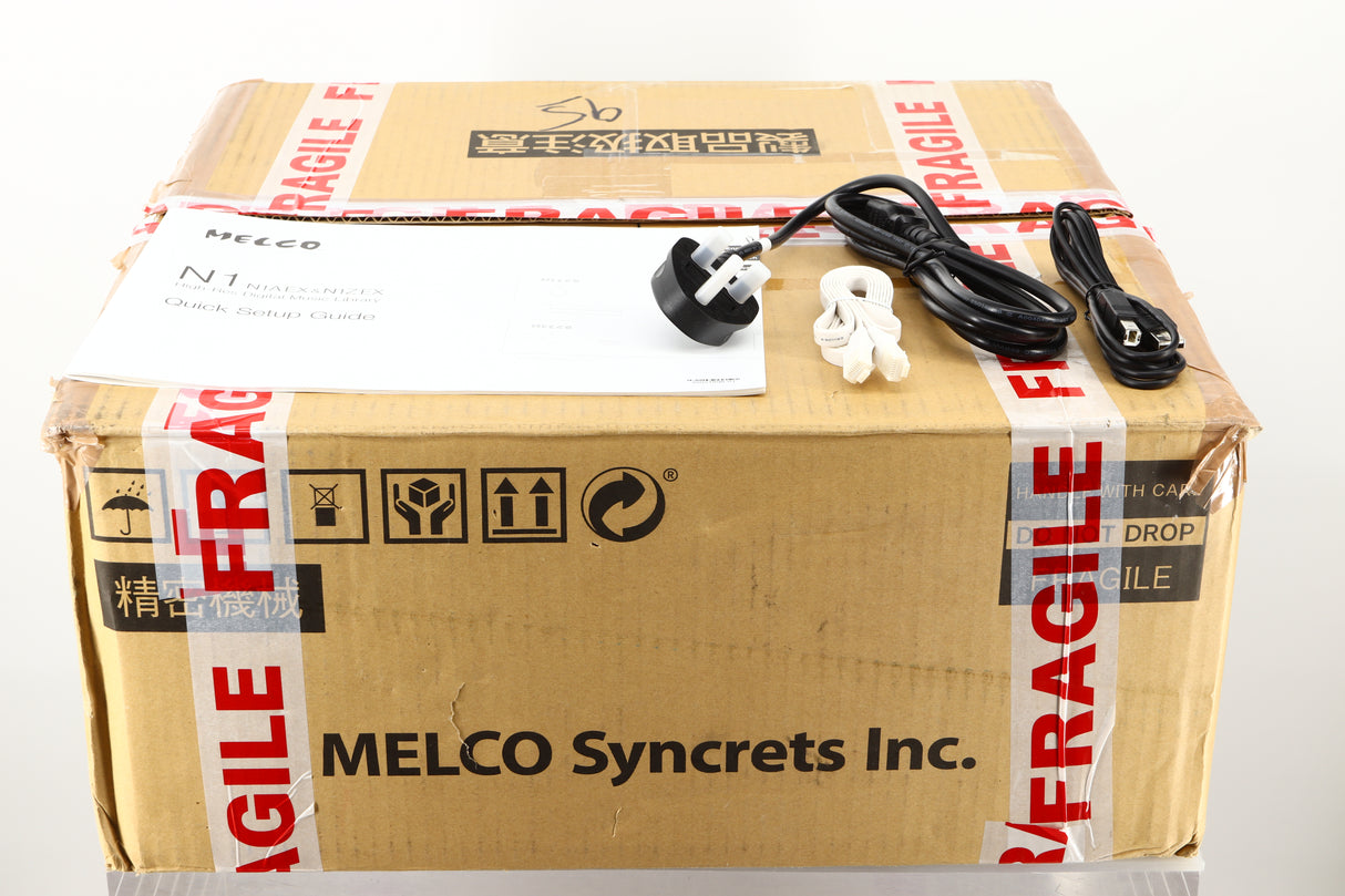 Box of a used Melco HA-N1Z/2EX-H60 Music Server in Black finish showing manual, mains cable, ethernet cable, and USB cable