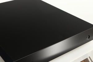 Close up of a used Melco N1A Music Server in a black finish showing small indent on top