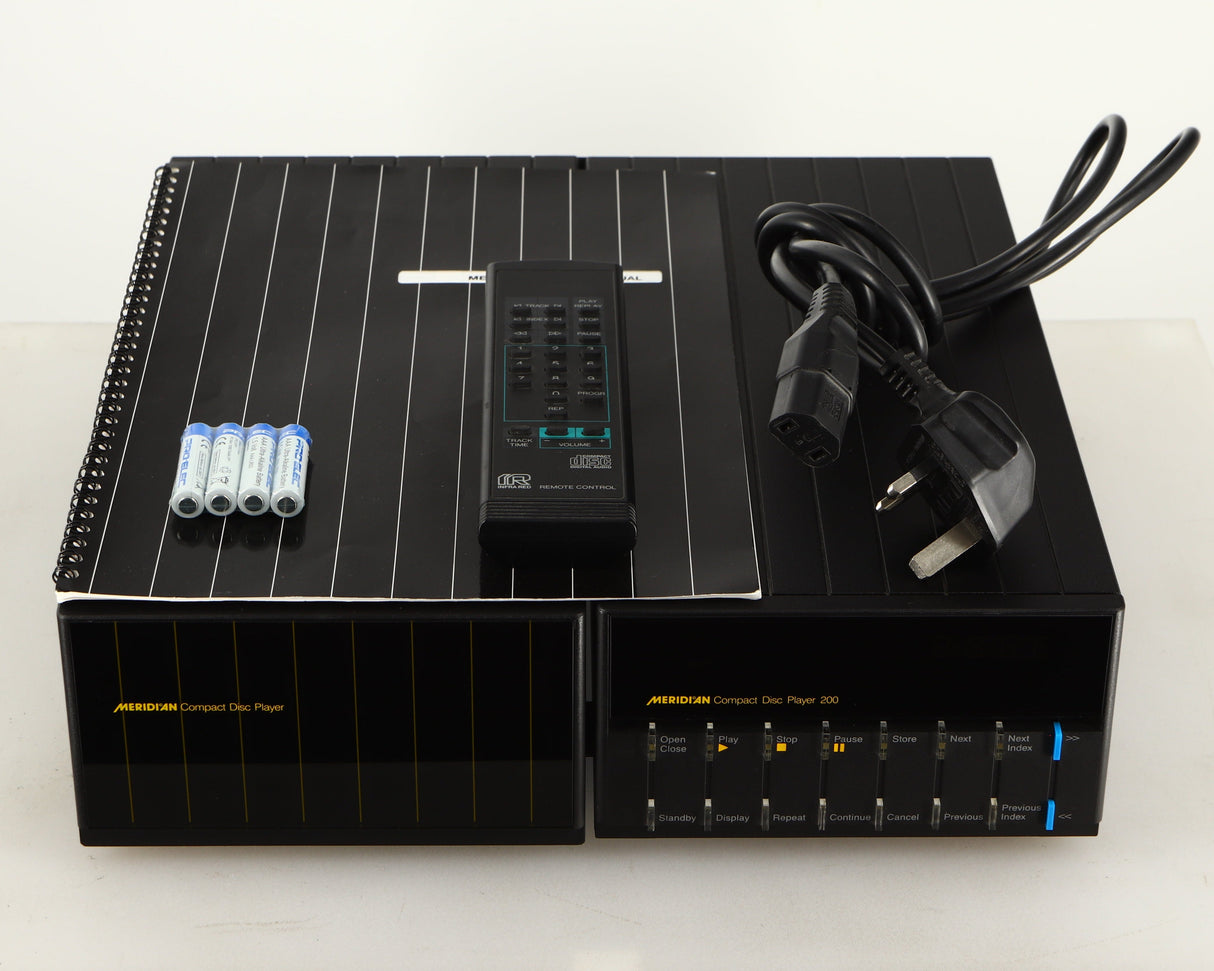 Top of a used Meridian 200 CD Transport in a black finish showing Manual, Remote, Batteries and Mains Cable