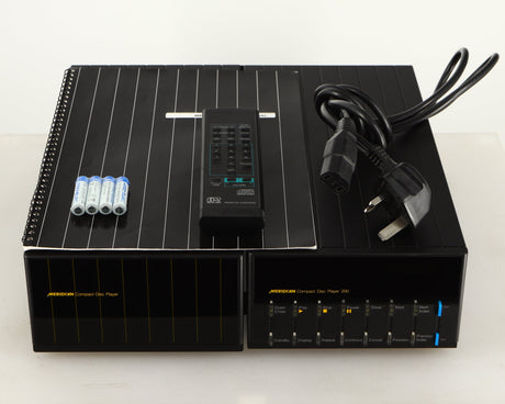 Top of a used Meridian 200 CD Transport in a black finish showing Manual, Remote, Batteries and Mains Cable