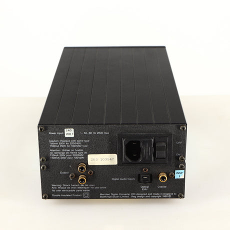 Rear view of a used Meridian 203 Digital Analogue Converter in a black finish showing Mains Input, Phono Input, Phono Outputs and Optical Input