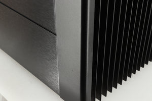 Close up of a used Meridian 557 Power Amplifier in a black finish showing a small scratch on fascia