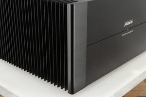 Front left corner of a used Meridian 557 Power Amplifier in a black finish