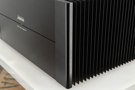 Front right corner of a used Meridian 557 Power Amplifier in a black finish