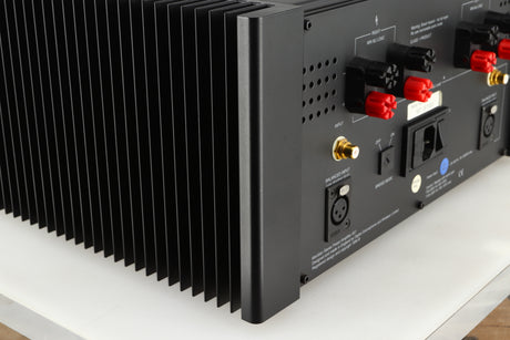 Rear right corner of a used Meridian 557 Power Amplifier in a black finish
