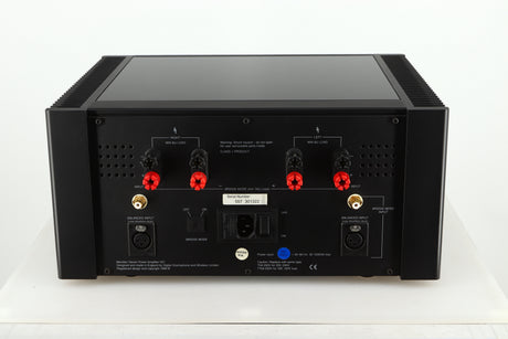 Rear view of a used Meridian 557 Power Amplifier in a black finish showing Speaker Inputs, Balance Inputs and Mains Input