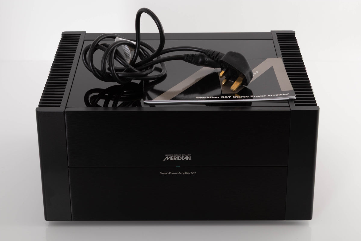 Front view of a used Meridian 557 Stereo Power Amplifier with mains cable, and manual
