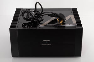 Front view of a used Meridian 557 Stereo Power Amplifier with mains cable, and manual