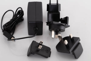 Accessories for a used Meridian Director Digital Analogue Converter in a Black finish showing PSU, Mains Plug and Schuko Plug