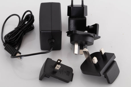 Accessories for a used Meridian Director Digital Analogue Converter in a Black finish showing PSU, Mains Plug and Schuko Plug