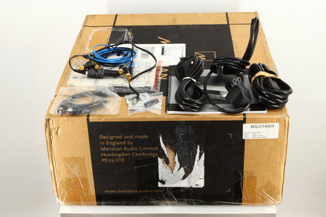 Box for a used Meridian G61R Controller in a silver finish showing Interconnect Cables, Manual, DIN Cable, Schuko Cable, Comms Cables