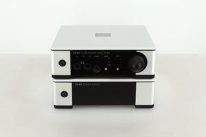 Front view of a used Meridian Prime Headphone Amplifier and Power Supply in silver finish