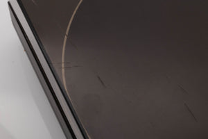 Close up view of a used Mission 775LC Turntable showing scratches on the lid